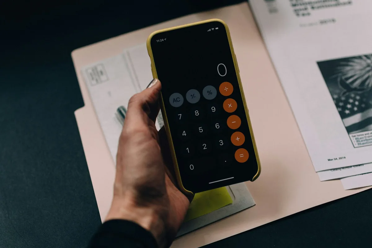 Smartphone calculator over household paperwork